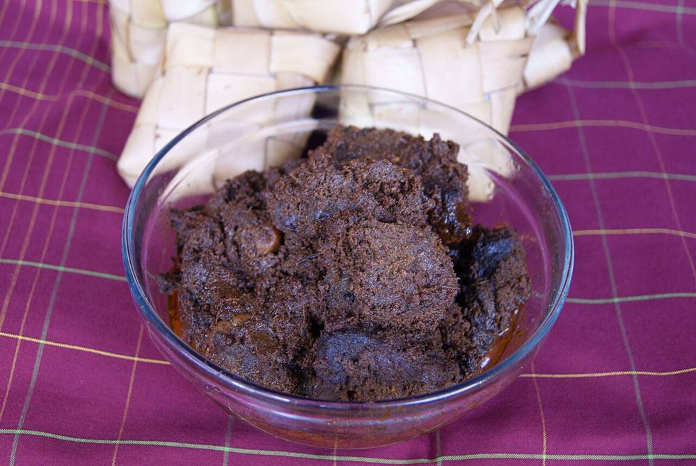 Dark beef rendang, the sauce reduced to a clinging crust, served in a Padang restaurant