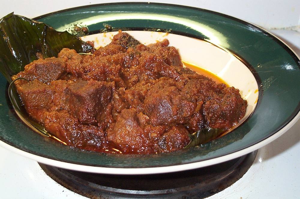 A plate of lamb rendang with rice