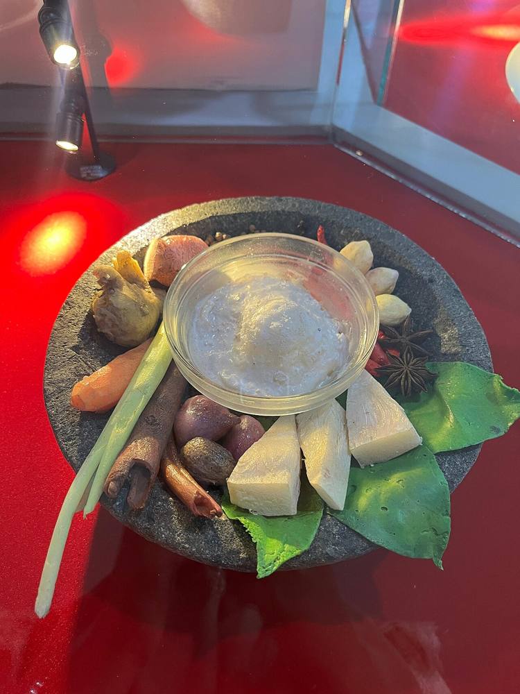 A rendang exhibition display at the Adityawarman Museum in Padang, with ingredients and cooking vessels laid out