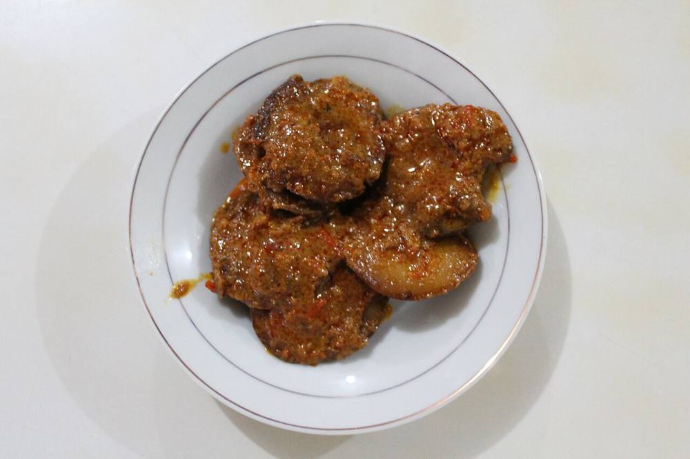 Rendang jengkol, flattened jengkol beans in dark coconut sauce